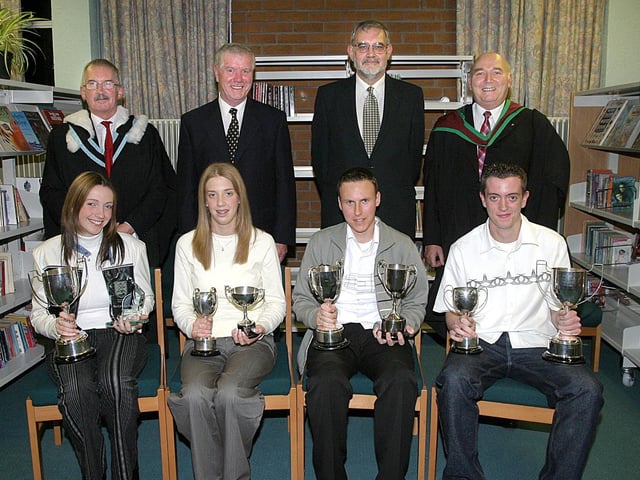Students who collected awards at Clondermot High School's annual Prize-Giving. Seated (from left), Catherine Pollock, PTA cup for Outstanding Service to the School and the cup for Advanced Science in Year 14, Claire Smith, cup for Academic Excellence, and the cup for Religious Education, Gary Orr, trophy for Effort and Achievement and for General Excellence in Year 12, and Nigel Campbell, the PTA cup for Outstanding service to the School and the cup for Advanced IT in Year 14.  Standing (from left) are Robert Logue, vice-principal, Bertie Faulkner, chairman of the Schools Board of Governors, Rev. Bert Tosh, guest speaker and John Magowan, Headmaster. (2810T05).:Derry and Donegal secondary school pupils in October 2003