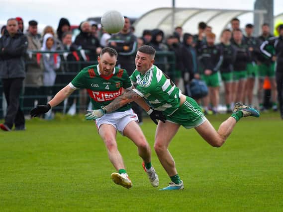 Slaughtmanus' Eamon Deery and Faughanvale's Mark Creane battle for possession during Saturday's IFC Relegation Playoff at Doire Trasna. Photo: George Sweeney