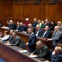 Members of the DUP listen to Ulster Unionist Party MLA Robbie Butler at the recall of the Stormont Assembly on Wednesday.