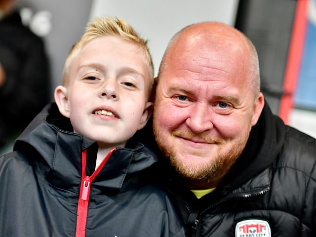 These Derry City supporters pose for a photograph before the game.