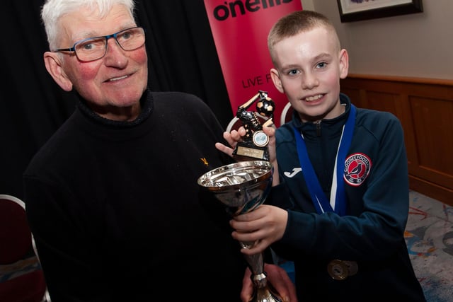 John ‘Jobby’ Crossan presenting the u-12 Player of the Year trophy to Sam Turner, Clooney FC, at the Annual Awards in the City Hotel on Friday night last. 
