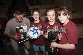 Liverpool and Northern Ireland defender Conor Bradley pictured at the launch of the O’Neills Foyle Cup at Ulster University (Magee) on Friday afternoon with three young ladies from Ballynahinch Olympic who will participate in this year’s tournament. From left, Megan McGreevy, Ava Gordon and Chloe McGreevy.