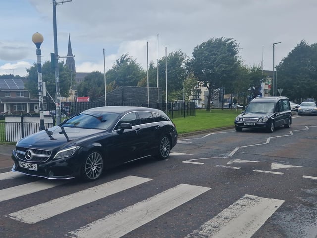 Nell McCafferty's funeral cortege makes it way through her beloved Bogside.