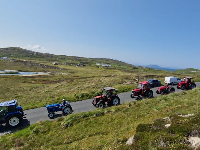 Some of the drivers and passengers taking off at the Inish Tractor Run.