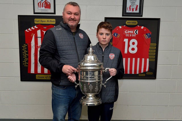 Derry City fans Colin Doherty and Corey Filler pictured with the FAI Cup at the Ryan McBride Brandywell Stadium.