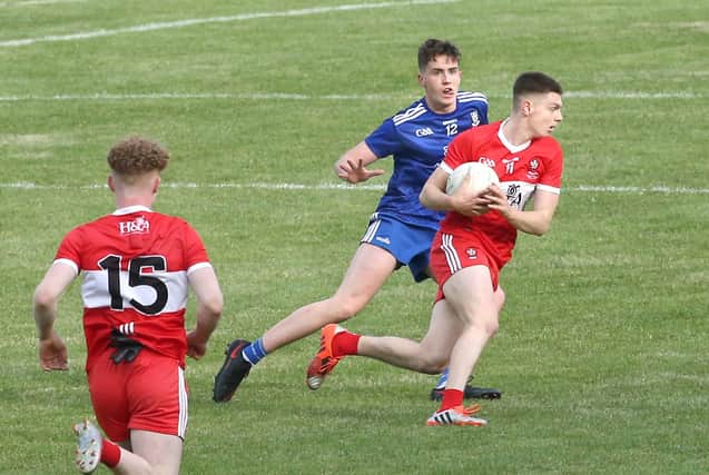 Matthew Downey takes on Monaghan's Ryan Duffy during 2020 Ulster Minor Football Championship Final.