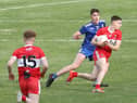 Matthew Downey takes on Monaghan's Ryan Duffy during 2020 Ulster Minor Football Championship Final.