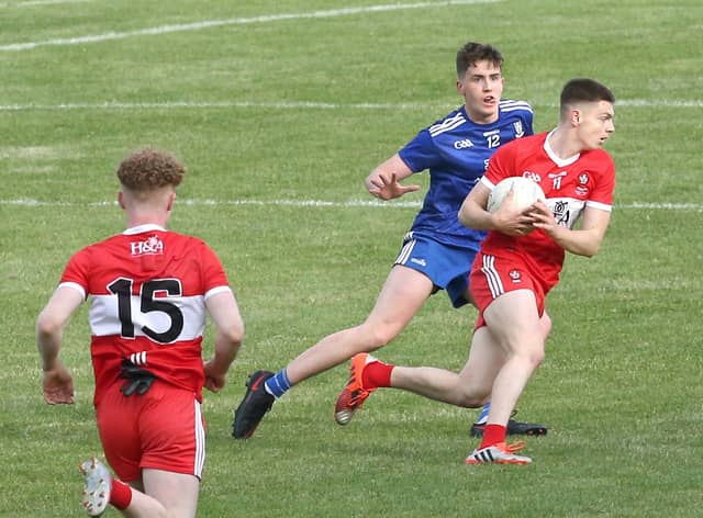 Matthew Downey takes on Monaghan's Ryan Duffy during 2020 Ulster Minor Football Championship Final.