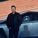 Tesla co-founder and CEO Elon Musk stands in front of the shattered windows of Tesla's Cybertruck at Tesla Design Center in Hawthorne, California on November 21, 2019. (Photo by FREDERIC J. BROWN / AFP) (Photo by FREDERIC J. BROWN/AFP via Getty Images)