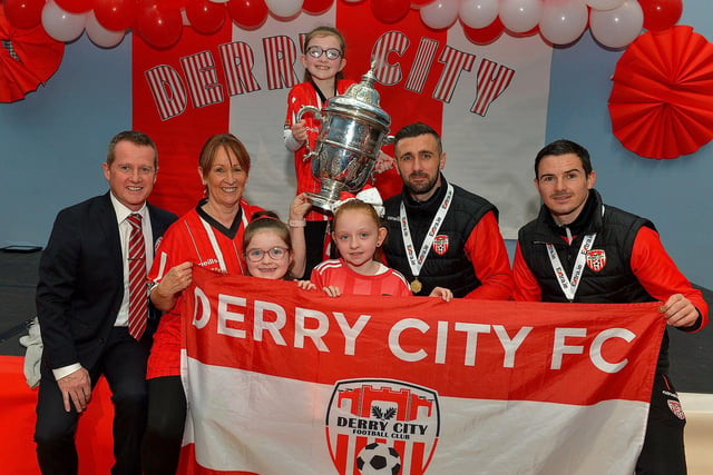 Derry City defenders Daniel Lafferty and Ciaran Coll pictured with Susan Green and her grandchildren Kadie Robinson, Hollie Robinson, and Kayln Green at St Eithnes Primary School during a visit, with the FAI Cup, on Wednesday morning. Included in the photograph is Mr Terence McDowell, school principal. Photo: George Sweeney.  DER2246GS  078