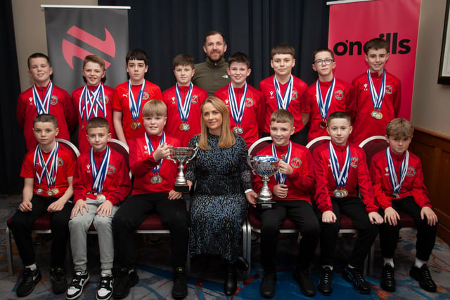 Caroline Casey, manager, O’Neills Sports Superstore, Derry presenting the League Trophy and Willie Curran Memorial Cup  to winners Newell Academy 2010s at the Annual Awards in the City Hotel on Friday night last. Included is coach Sandy Gillespie. (Photos: Jim McCafferty Photography)