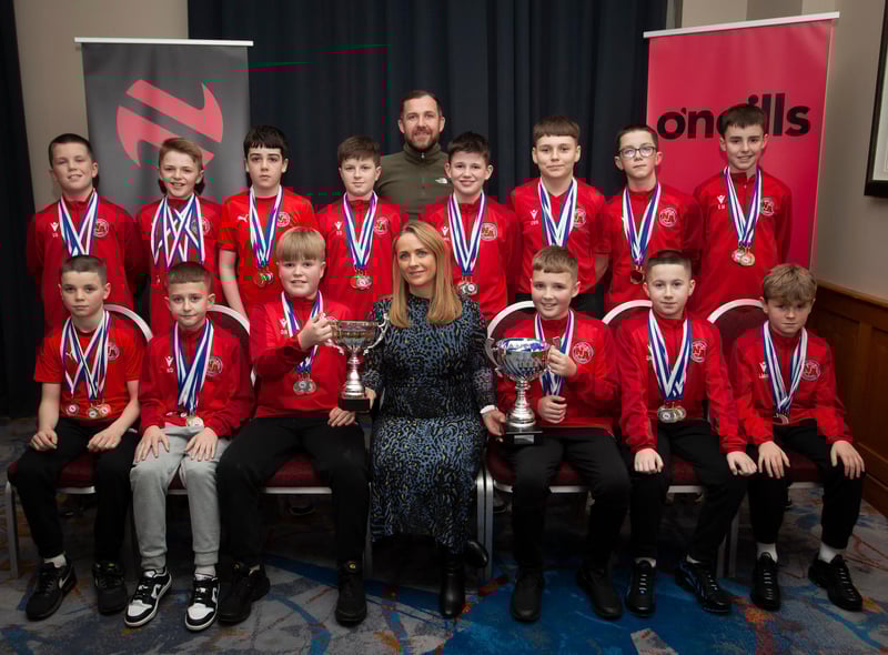 Caroline Casey, manager, O’Neills Sports Superstore, Derry presenting the League Trophy and Willie Curran Memorial Cup  to winners Newell Academy 2010s at the Annual Awards in the City Hotel on Friday night last. Included is coach Sandy Gillespie. (Photos: Jim McCafferty Photography)