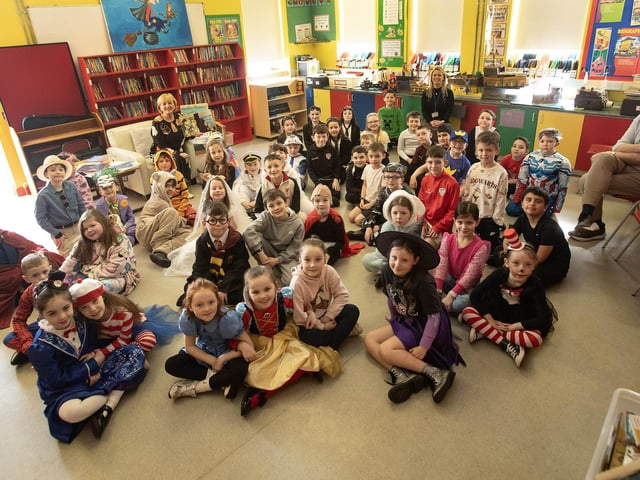 Storyteller Mrs. Evelyn O'Donnell was at Hollybush PS on Thursday for World Book Day and is pictured with pupils in the library to celebrate the event. Included are Mr. Devlin and Mrs. O'Donnell. (Photos: Jim McCafferty Photography)
