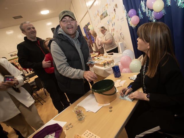 Ms. Catherine Doorish (Principal) busy selling tickets at Friday's Charity Coffee Morning in Steelstown PS.