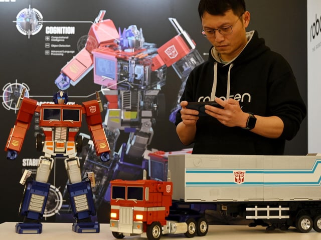 Transformers (robots in disguise) arrived from outer space in 1984 and have been with us ever since. Here an employee operates the interactive and self-transforming robot of the Transformer series, Optimus Prime during the press preview of the 72th toy fair (Spielwarenmesse), in Nuremberg, southern Germany. (Photo by CHRISTOF STACHE/AFP via Getty Images)
