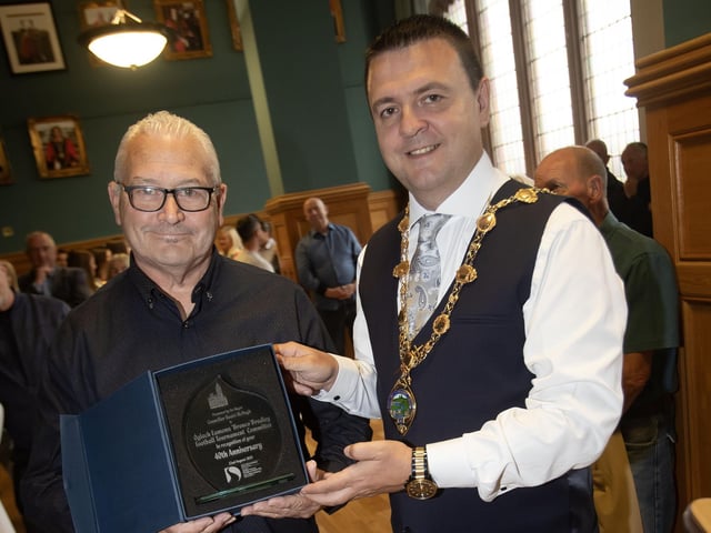 The Mayor of Derry City and Strabane District Council, Ruairi McHugh making a presentation to Martin 'Gills' McGilloway, chair of the Eamonn 'Bronco' Bradley Football Tournament Committee in recognition of their 40th anniversary on Friday evening at the Guildhall. (Photos: Jim McCafferty Photography)