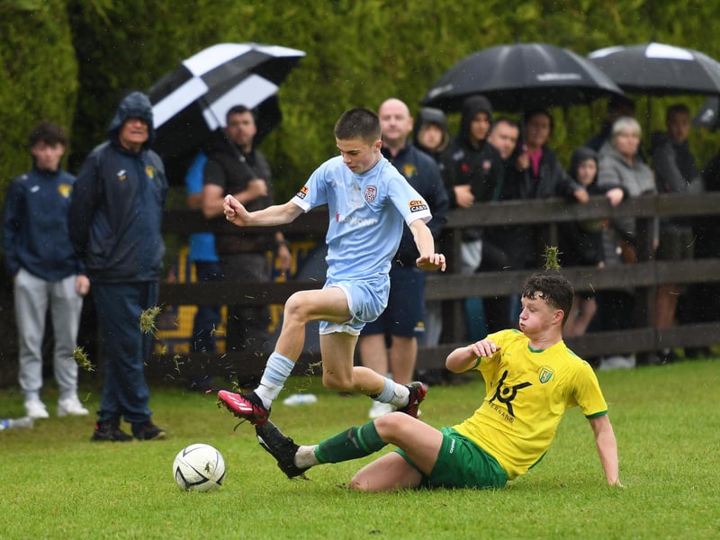 Derry City's Tiernan Brolly hurdles this tackle from Donegal UL defender Conail Flannery during their O'Neills Foyle Cup Under-15's final at Ardmore.