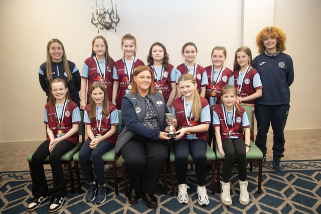 Newbuildings U-11s receive the Summer Cup trophy from Charlene Morris, Derry Credit Union at the D&D Youth FA awards at the Waterfoot Hotel on Sunday night last. Included is coachesSienna Hickey and Zahara Lecky.