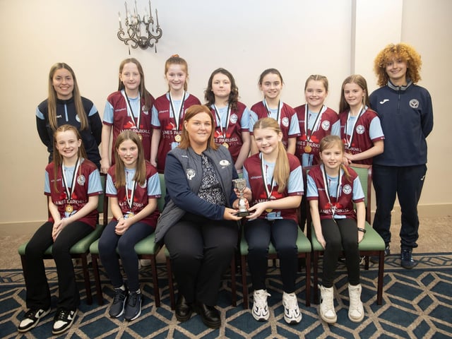 Newbuildings U-11s receive the Summer Cup trophy from Charlene Morris, Derry Credit Union at the D&D Youth FA awards at the Waterfoot Hotel on Sunday night last. Included is coachesSienna Hickey and Zahara Lecky.