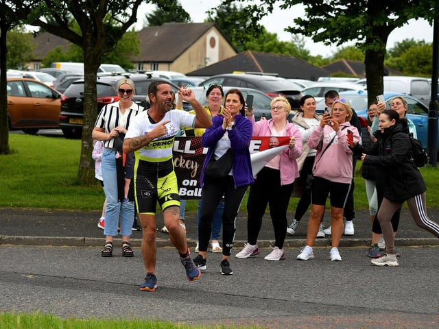 Fans cheer on Mickey Doherty during Sunday morning's Liam Ball Triathlon.