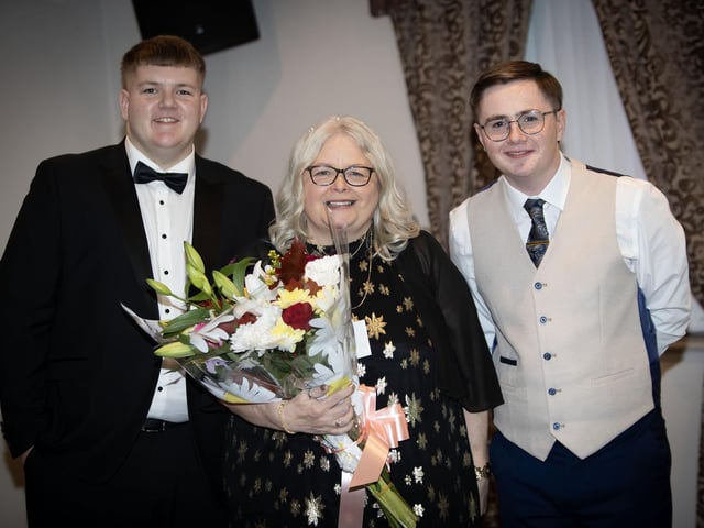 Sixth Year Supervisor Mrs. Paula Dillon being presented with a bouquet of flowers by Michael McGavigan and Evan Curran on Friday night. (Photos: Jim McCafferty Photography) : .