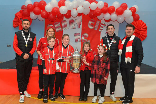 Derry City defenders Daniel Lafferty and Ciaran Coll pictured with the Conaghan family St Eithnes Primary School during a visit, with the FAI Cup, on Wednesday morning. From left are Michelle Conaghan, P5 teacher, Tom, Dara, Portia, Jemma and Sean Conaghan VP. Photo: George Sweeney.  DER2246GS  077
