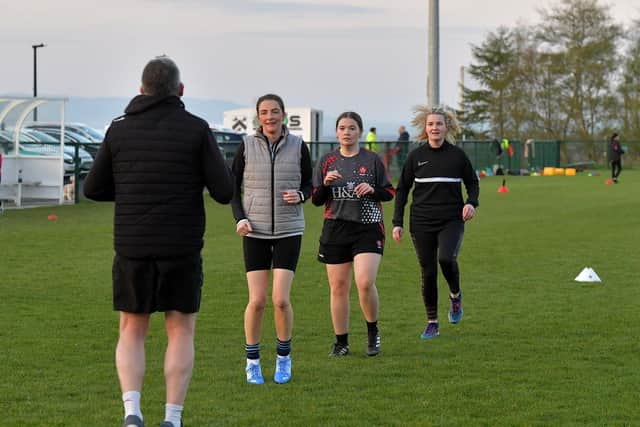 Warm-up exercises ahead of Doire Trasna’s first Mothers and Others football practice session, at Corrody Road. Photo: George Sweeney. DER2316GS – 15