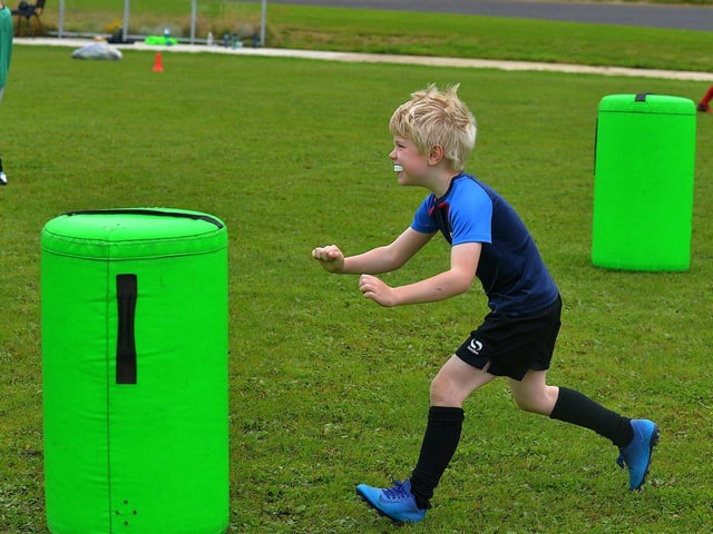 Young participant develops his tackling skills at the recent City of Derry Youth Rugby Summer Camp. Photo: George Sweeney. DER2331GS – 55