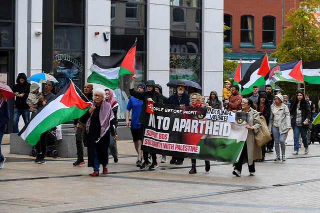 People make their way from Free Derry Wall to Guildhall Square to hear Palestinian photojournalist Motaz Azaiza. Photo: George Sweeney