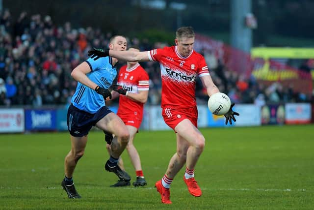 Derry’s Emmett Bradley gets off a shot as Dublin’s Peadar O Cofaigh Byrne closes in. Photo: George Sweeney