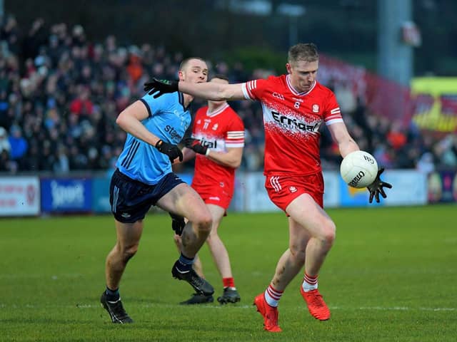 Derry’s Emmett Bradley gets off a shot as Dublin’s Peadar O Cofaigh Byrne closes in. Photo: George Sweeney