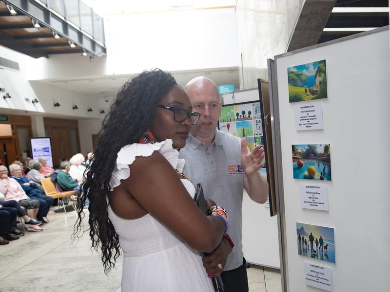 Project Director at the Old Library Trust, George McGowan shows Mayor, Lillian Seenoi-Barr some of the artwork on display during Wednesday's DEEDS exhibition at the Millennium Forum, Derry.