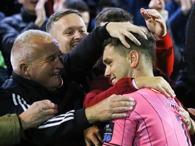 Derry City goalkeeper receives a hug from his mother as Derry City fans reach out to congratulate him on reaching a second FAI Cup Final in three years.