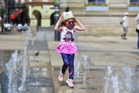 Five-year-old Derry girl Billie – Rose McKinney playing at the water fountains in Guildhall Square. Photo: George Sweeney