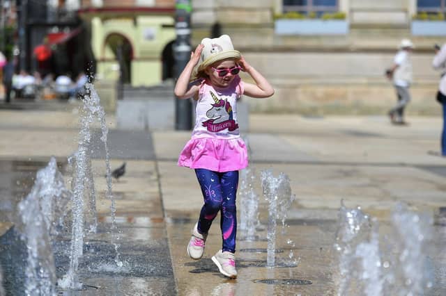 Five-year-old Derry girl Billie – Rose McKinney playing at the water fountains in Guildhall Square. Photo: George Sweeney