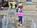Five-year-old Derry girl Billie – Rose McKinney playing at the water fountains in Guildhall Square. Photo: George Sweeney