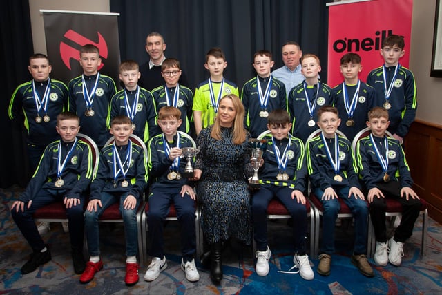 Caroline Casey, manager, O’Neills Sports Superstore, Derry presenting the League and Cup trophies to Sion Swifts 2010s, at the Annual Awards in the City Hotel on Friday night last. Included are coaches Derek Maxwell and Shane Patterson. (Photos: Jim McCafferty Photography)