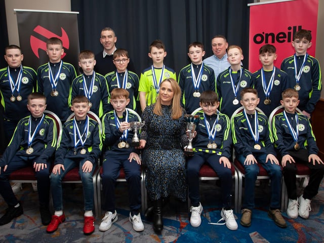 Caroline Casey, manager, O’Neills Sports Superstore, Derry presenting the League and Cup trophies to Sion Swifts 2010s, at the Annual Awards in the City Hotel on Friday night last. Included are coaches Derek Maxwell and Shane Patterson. (Photos: Jim McCafferty Photography)