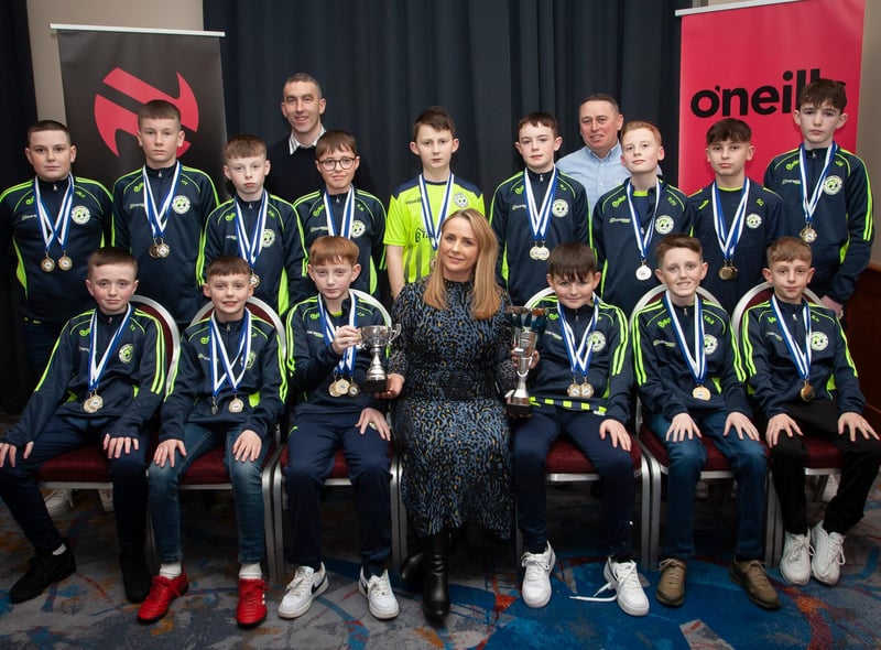 Caroline Casey, manager, O’Neills Sports Superstore, Derry presenting the League and Cup trophies to Sion Swifts 2010s, at the Annual Awards in the City Hotel on Friday night last. Included are coaches Derek Maxwell and Shane Patterson. (Photos: Jim McCafferty Photography)