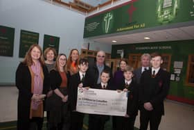 CHILDREN IN CROSSFIRE CHEQUE. . . . .Pupils and staff from St. Joseph’s Boys School pictured handing over a cheque for £857.14 to Children in Crossfire, monies raised through a recent Pier Jump at the local Creggan Reservoir. Accepting the cheque was Richard Moore and Shauna O’Neill from Children in Crossfire and school staff include Mr. Paul Kealey, Vice Principal, Fiona Page, Anne-Marie Faulkner and Catherine Logan. (Photo: Jim McCafferty Photography)