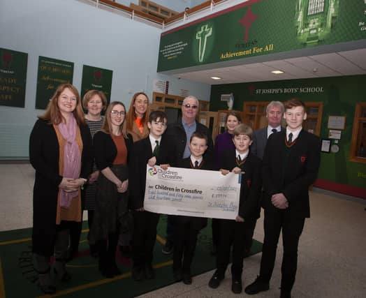CHILDREN IN CROSSFIRE CHEQUE. . . . .Pupils and staff from St. Joseph’s Boys School pictured handing over a cheque for £857.14 to Children in Crossfire, monies raised through a recent Pier Jump at the local Creggan Reservoir. Accepting the cheque was Richard Moore and Shauna O’Neill from Children in Crossfire and school staff include Mr. Paul Kealey, Vice Principal, Fiona Page, Anne-Marie Faulkner and Catherine Logan. (Photo: Jim McCafferty Photography)