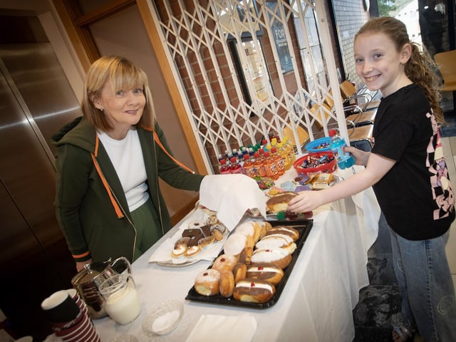 CU volunteeer Deirdre Ashford serving up some delights to Credit Union member Grace Cooke (9) on Saturday. : .