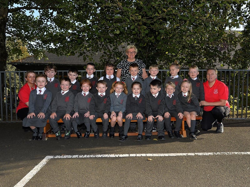 Teacher Mrs McGrellis (centre) with P1 pupils and classroom assistants at Holy Family Primary School.