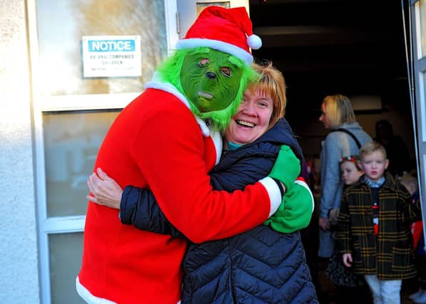Lynn pictured with the Galliagh Grinch at the Galliagh Community Response Christmas Craft Fair held in Pio House Parish Centre on Saturday, in aid of Foyle Down Syndrome Trust. Photo: George Sweeney. DER2250GS – 89