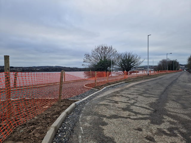 Works are steadily progressing on the new Derry bridge, which is due to be completed by Spring this year. The riverside path connecting the Bay Road Nature Reserve to the new bridge has kerbs and gravel laid and lampposts almost fully installed. The base for the bridge to sit on the Bay Road side seems to be fully complete with concrete being pored on the other side's base.
