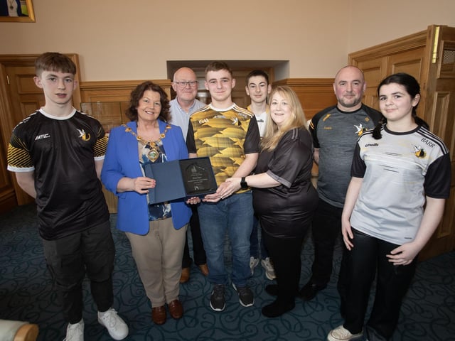 The Mayor of Derry City and Strabane District Council, Patricia Logue pictured presenting Oisin Barr with recognition of his achievement of being Translink Ulster GAA Young Volunteer of the Year 2023, at a reception in his honour in the Guildhall on Wednesday evening. Included from left are Riain, brother, Clive Roylancell, uncle, Fionan, brother, Colleen, mum, Eohgan, dad and Eibhlin, sister.