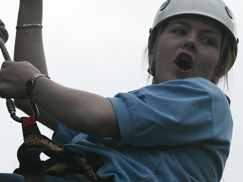 Cub Scout leader Emma McNulty hanging around during a wall climb. (1605JB22)