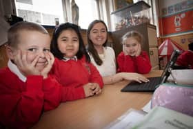 Primary 1 teacher Miss McNutt doing some work with pupils Kai, Athena and Mia as they started school at St. Eugene's PS. Photo: Jim McCafferty