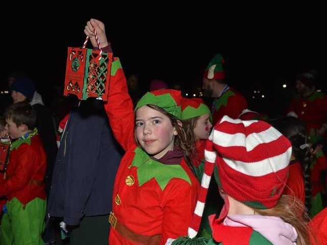 Culmore Community Partnership Elf Parade makes its way towards the Community Hub on Friday night. Photo: George Sweeney