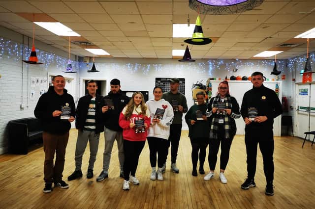 CRJ staff Mickey Anderson(left) and Eamon Mc Ginley (right) pictured with Youth leaders from the Glen and Rosemount at the fireworks safety work